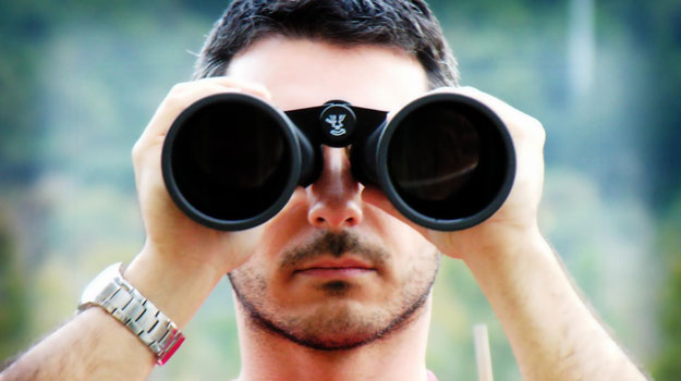 5 Uncommon SEO Tips for WordPress Serious looking man with binoculars - looking for Less Common WordPress SEO Tips